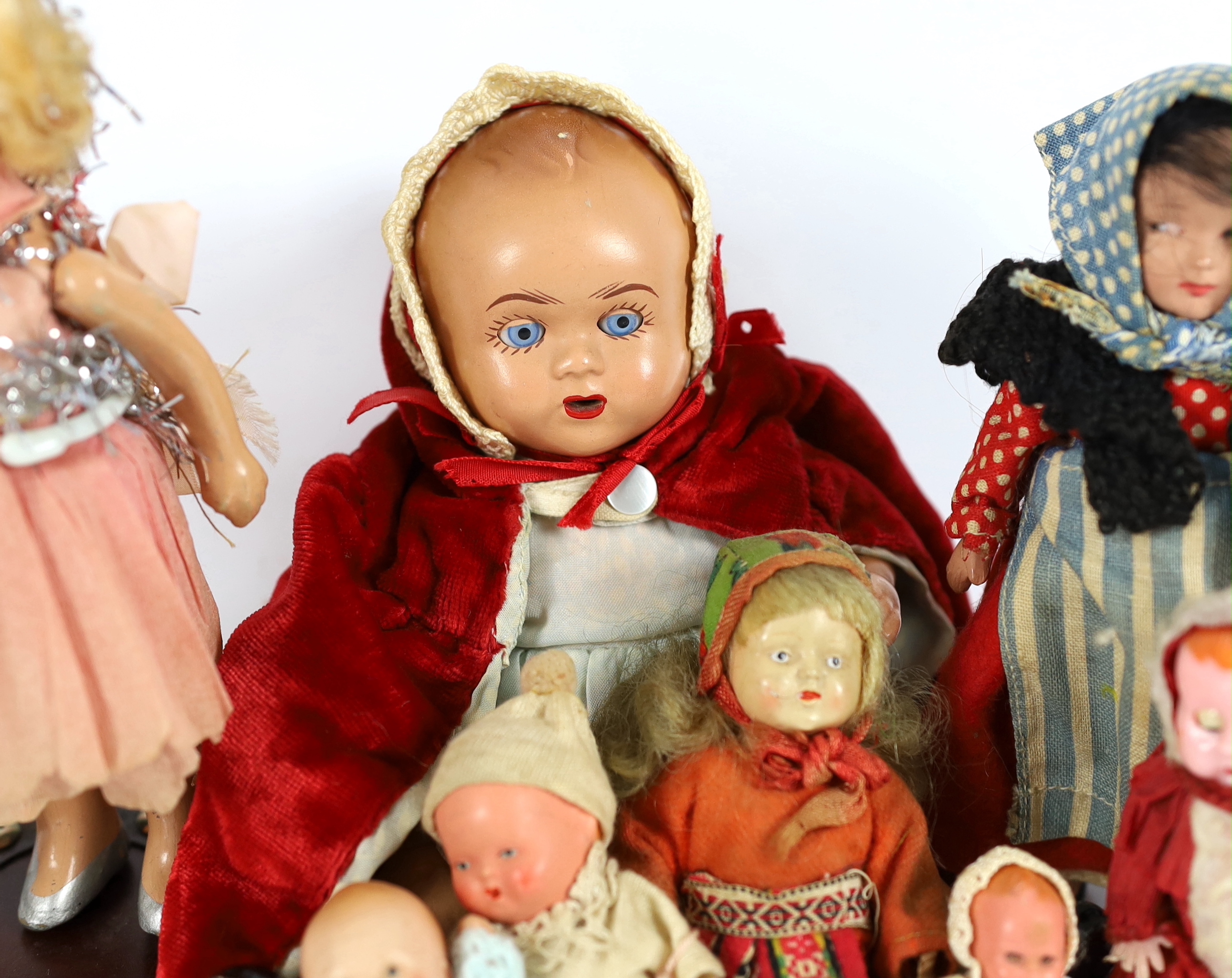 Nine assorted small dolls, mainly composition or plastic